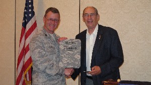 Col. Fred Eisele, USA (Ret.) (r), chapter vice president for programs, presents a memento to Lt. Col. Daniel Steele, USAF, commander of the 45th U.S. Air Force Space Communications Squadron, following his speech at the May meeting.